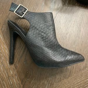 Black ankle boots with pointed toe and open back.